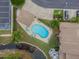 Aerial view of the community pool, landscaping, and nearby waterway; a gorgeous Florida oasis at 9012 Antigua Dr, Seminole, FL 33777