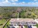 Aerial view of townhome complex with mature trees and landscaping at 9012 Antigua Dr, Seminole, FL 33777