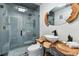 Unique bathroom design featuring a vessel sink, wood accents, and walk-in shower at 9012 Antigua Dr, Seminole, FL 33777