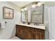 Bathroom featuring a double sink vanity and a glass block shower at 9012 Antigua Dr, Seminole, FL 33777