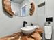 Contemporary bathroom featuring a wood countertop, vessel sink, and modern fixtures at 9012 Antigua Dr, Seminole, FL 33777