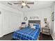 Bedroom with closet, overhead fan, dark wood floors and blue-and-white bedding at 9012 Antigua Dr, Seminole, FL 33777