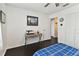 Comfortable bedroom featuring dark wood floors, white closet doors, and a ceiling fan at 9012 Antigua Dr, Seminole, FL 33777