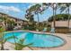 Community pool with lounge chairs surrounded by lush landscaping offering a tranquil and relaxing environment at 9012 Antigua Dr, Seminole, FL 33777