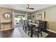 Inviting dining room with dark wood floors, a ceiling fan and sliding glass doors to the outdoor patio at 9012 Antigua Dr, Seminole, FL 33777