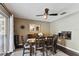 Warm and inviting dining area with a modern ceiling fan, a fireplace, and a large decorative mirror at 9012 Antigua Dr, Seminole, FL 33777