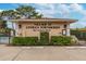 Entrance to the Village at Antigua Townhomes with well-maintained landscaping and guest parking spots at 9012 Antigua Dr, Seminole, FL 33777