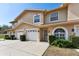 Charming townhouse with a two-car garage, manicured landscaping, and a welcoming front entrance at 9012 Antigua Dr, Seminole, FL 33777