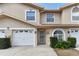 Charming townhome with a well maintained front yard, featuring a garage and decorative front entrance at 9012 Antigua Dr, Seminole, FL 33777