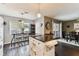 Charming kitchen featuring a large window, kitchen island, and seamless flow into dining area at 9012 Antigua Dr, Seminole, FL 33777