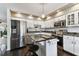 Spacious kitchen featuring stainless steel appliances, granite countertops, white cabinets, and a kitchen island at 9012 Antigua Dr, Seminole, FL 33777