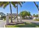 Antigua community sign with palm trees and glimpses of residential buildings at 9012 Antigua Dr, Seminole, FL 33777