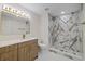 Bathroom featuring white stone countertops, modern wood cabinetry and stunning marbled tile shower at 934 W Wheeler Rd, Brandon, FL 33510