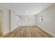 Bright bedroom with wood floors, neutral walls, and barn door leading to bathroom at 934 W Wheeler Rd, Brandon, FL 33510