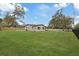 Wide shot of the front of the home and front yard with the fence on the right side at 934 W Wheeler Rd, Brandon, FL 33510