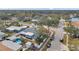 Aerial view of a neighborhood showcasing mature landscaping, a pool, and well-kept properties at 9394 117Th Ave, Largo, FL 33773