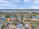 Overhead shot displaying houses in a lakeside community that offers waterfront residences in a tree filled landscape at 9394 117Th Ave, Largo, FL 33773