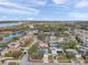 Expansive aerial view of neighborhood homes interspersed among mature trees near a tranquil lake at 9394 117Th Ave, Largo, FL 33773