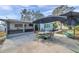 Enjoy the outdoors on this home's back patio with an umbrella covered table and chairs at 9394 117Th Ave, Largo, FL 33773