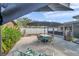 Enjoy the outdoors on this home's back patio with an umbrella covered table and chairs at 9394 117Th Ave, Largo, FL 33773