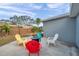 This backyard features a fire pit and colorful chairs, perfect for relaxing with friends and Gathering at 9394 117Th Ave, Largo, FL 33773