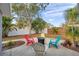 This backyard features a fire pit and colorful chairs, perfect for relaxing with friends and Gathering at 9394 117Th Ave, Largo, FL 33773