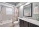 Cozy bathroom with shower-tub combo, framed mirror, and updated vanity at 9394 117Th Ave, Largo, FL 33773