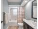 Nicely lit bathroom featuring a shower-tub, dark vanity, and tile flooring at 9394 117Th Ave, Largo, FL 33773