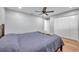 Neutral toned bedroom featuring a ceiling fan, new flooring, and a closet at 9394 117Th Ave, Largo, FL 33773