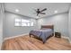 Well-lit bedroom with new flooring, ceiling fan, and a comfortable bed at 9394 117Th Ave, Largo, FL 33773