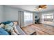 Light-filled bedroom with sliding glass doors, ceiling fan and an adjacent workstation at 9394 117Th Ave, Largo, FL 33773