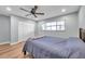 Clean bedroom featuring a ceiling fan, new flooring, and a closet for storage at 9394 117Th Ave, Largo, FL 33773