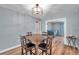 Bright dining room with light blue walls, wood floors and an open doorway to a bedroom at 9394 117Th Ave, Largo, FL 33773