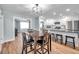 Dining room with wood-look flooring, modern lighting, and seamless access to the kitchen and living room at 9394 117Th Ave, Largo, FL 33773