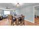 Open floor plan dining room with wood floors, modern light fixture, and view of the living room at 9394 117Th Ave, Largo, FL 33773