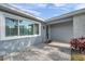 Exterior view of a well-maintained home featuring a tiled front porch and well-lit entryway at 9394 117Th Ave, Largo, FL 33773