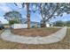 Landscaped front lawn, large trees, and a driveway at 9394 117Th Ave, Largo, FL 33773