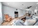 Inviting living room with wood-look floors, comfortable seating, ceiling fan, and a seamless flow to the dining area at 9394 117Th Ave, Largo, FL 33773