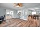 Open living area with wood floors and an open plan view to the kitchen and dining area at 9394 117Th Ave, Largo, FL 33773