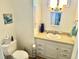 Bathroom featuring a toilet, single sink vanity, and tiled walls at 9790 66Th N St # 235, Pinellas Park, FL 33782