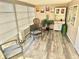 Bright sunroom with laminate flooring, a variety of seating options and a built-in cabinet for a relaxing space at 9790 66Th N St # 235, Pinellas Park, FL 33782