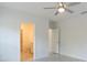 Bedroom view featuring neutral paint, ceiling fan and a view into the adjacent bathroom at 1018 Blakley St, Punta Gorda, FL 33980