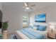 Cozy bedroom featuring a ceiling fan, soft lighting, and a window offering a pleasant view at 1018 Blakley St, Punta Gorda, FL 33980