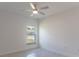 Bedroom featuring neutral paint, tiled floors, a ceiling fan and window allowing natural light at 1018 Blakley St, Punta Gorda, FL 33980