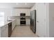 Bright kitchen with stainless steel appliances, white cabinetry, stylish backsplash, and tile flooring at 1018 Blakley St, Punta Gorda, FL 33980