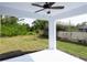 Covered patio with ceiling fan overlooks a spacious backyard with a partial fence line for privacy at 1018 Blakley St, Punta Gorda, FL 33980