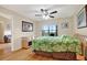 Bright bedroom featuring a ceiling fan, wood floors and sliding glass doors to the balcony with a view at 11901 4Th N St # 6303, St Petersburg, FL 33716