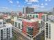 Aerial view of modern condominiums with colorful accents and lush landscaping in an urban setting at 1208 E Kennedy Blvd # 1115, Tampa, FL 33602