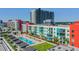 Aerial view showcasing a rooftop pool and lounge area amidst modern condo buildings at 1208 E Kennedy Blvd # 1115, Tampa, FL 33602