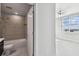 Bathroom with a shower, a large window and a modern toilet and vanity at 1208 E Kennedy Blvd # 1115, Tampa, FL 33602